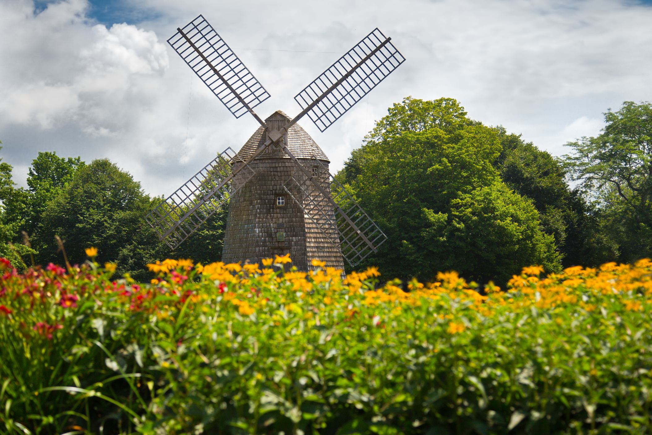 Historic windmill in the Hamptons surrounded by colorful flowers